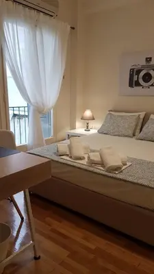 a bedroom with a large bed with a window at Begonia-Athens Center, 6 BD, 2,5 BATH in Athens