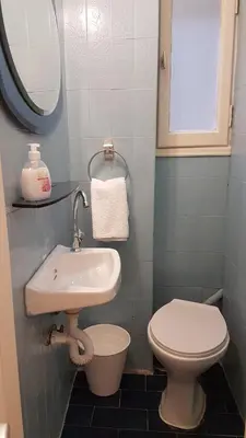 a small bathroom with a sink and a toilet at Begonia-Athens Center, 6 BD, 2,5 BATH in Athens