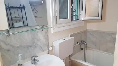 a bathroom with a white toilet and a sink at Coral Athens Centrer - 3,5 BD , 2 BATH in Athens