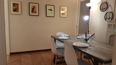 a dining room with a wooden table and white chairs at Coral Athens Centrer - 3,5 BD , 2 BATH in Athens