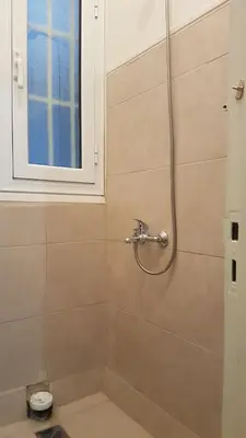 a bathroom with a shower with a toilet and a window at Coral Athens Centrer - 3,5 BD , 2 BATH in Athens