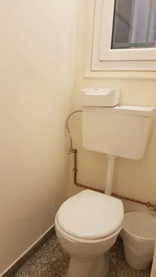 a bathroom with a white toilet and a window at Coral Athens Centrer - 3,5 BD , 2 BATH in Athens