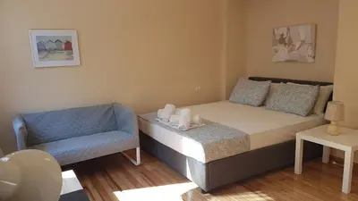 a small bedroom with a bed and a chair at Coral Athens Centrer - 3,5 BD , 2 BATH in Athens