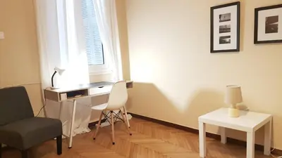 a desk and chair in a room with a window at Coral Athens Centrer - 3,5 BD , 2 BATH in Athens