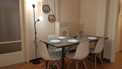 a dining room table with white chairs and a lamp at Coral Athens Centrer - 3,5 BD , 2 BATH in Athens
