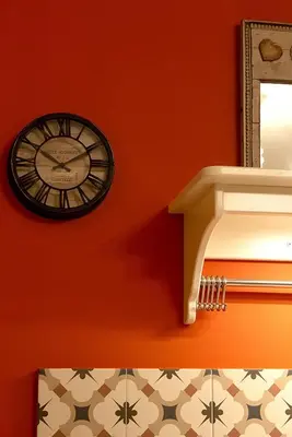 a clock hanging on a wall next to a mirror at Αcacia House - Fully Equipped Apartment in Glyfada in Athens