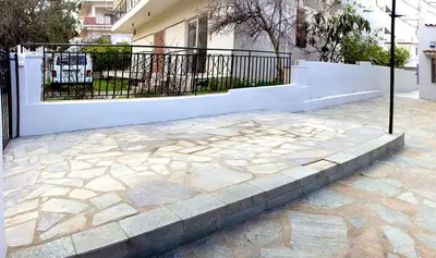 a white fence and a stone walkway in front of a house at Αcacia House - Fully Equipped Apartment in Glyfada in Athens