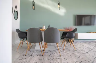 a dining room with a table and four chairs at Bright 3bdr Apt with Roofgarden, Jacuzzi in Athens