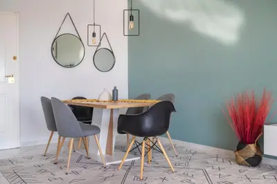 a dining room with a table with chairs and a mirror at Bright 3bdr Apt with Roofgarden, Jacuzzi in Athens