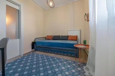 a room with a bed and a table in it at Bright 3bdr Apt with Roofgarden, Jacuzzi in Athens