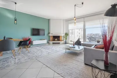 a living room with a couch and a fireplace at Bright 3bdr Apt with Roofgarden, Jacuzzi in Athens