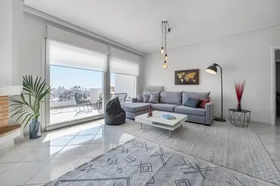 a living room with a couch and a table at Bright 3bdr Apt with Roofgarden, Jacuzzi in Athens