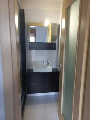 a bathroom with a sink and a mirror at summer-house in Metókhi
