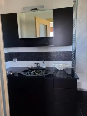 a bathroom with a sink and a mirror at summer-house in Metókhi