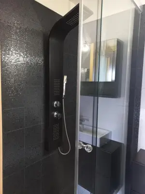 a bathroom with a shower with a glass door at summer-house in Metókhi