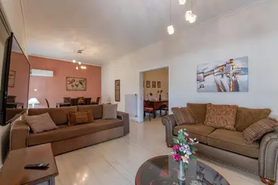 a living room with two couches and a table at Marina Zeas Classyhub in Piraeus