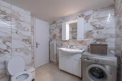 a bathroom with a washing machine and a sink at Marina Zeas Classyhub in Piraeus