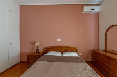 a bedroom with a bed and a dresser at Marina Zeas Classyhub in Piraeus