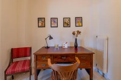 a desk with a chair and a lamp on top of it at Marina Zeas Classyhub in Piraeus