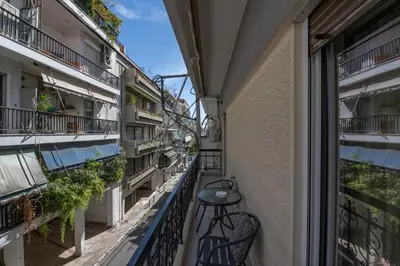 a balcony in a building with a table at Marina Zeas Classyhub in Piraeus