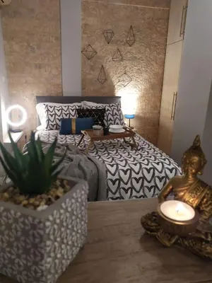 a bedroom with a bed and a table with a plant at Athenian Sun-Kissed Penthouse with huge Balcony! in Athens