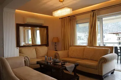 a living room with couches and a table at Glifada Calm Luxury Flat One in Athens