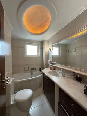 a bathroom with a toilet and a tub and a sink at Glifada Calm Luxury Flat One in Athens