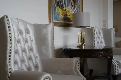 a room with two chairs and a table with a lamp at Glifada Calm Luxury Flat One in Athens