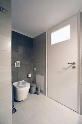 a white bathroom with a toilet and a shower at Νew Thission Luxury Apartment in Athens