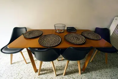 a wooden table with four black chairs around it at Νew Thission Luxury Apartment in Athens