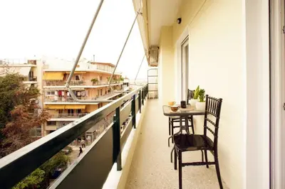 a balcony with a table and chairs on a building at Νew Thission Luxury Apartment in Athens