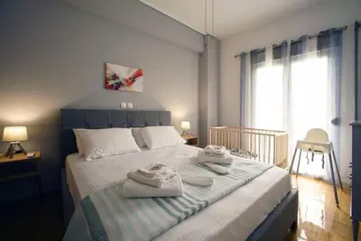 a bedroom with a bed with towels on it at Νew Thission Luxury Apartment in Athens
