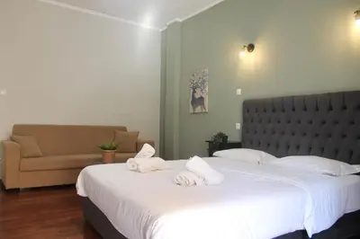 a bedroom with a large bed and a couch at Athens City Themis 12 in Athens