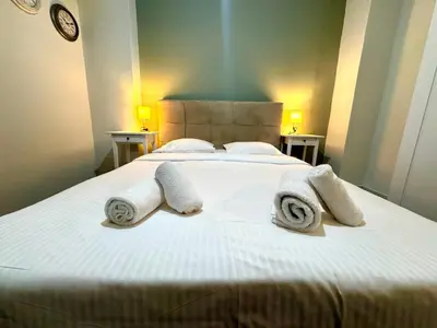 a bedroom with a bed with towels on it at Athens City Themis 12 in Athens