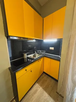 a kitchen with yellow cabinets and a sink at Athens City Themis 12 in Athens