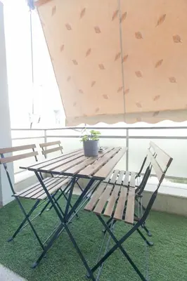 a picnic table with two chairs and a potted plant at Athens City Themis 12 in Athens