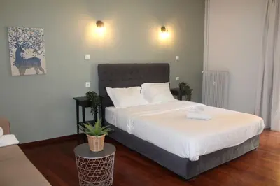 a bedroom with a large bed with white sheets at Athens City Themis 12 in Athens