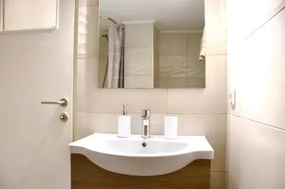 a bathroom with a white sink and a mirror at Kallithea's breeze in Athens