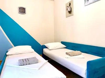 two beds in a room with blue and white at Kallithea's breeze in Athens