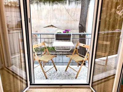 a pair of chairs sitting on a balcony at Kallithea's breeze in Athens