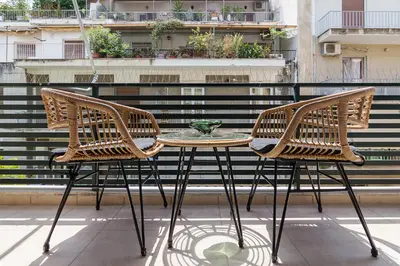 two chairs and a table on a balcony at Bright and Spacious 2-bedroom Apartment in Athens in Athens