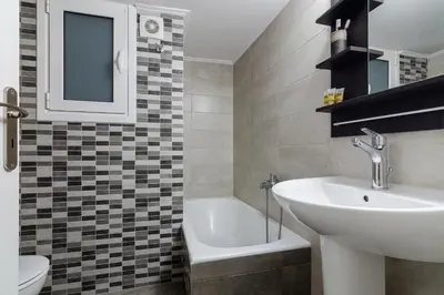 a bathroom with a sink and a toilet and a tub at Bright and Spacious 2-bedroom Apartment in Athens in Athens