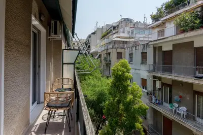 a chair sitting on a balcony of a building at Bright and Spacious 2-bedroom Apartment in Athens in Athens