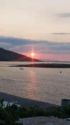 a sunset over a large body of water at Pallas in Keratea