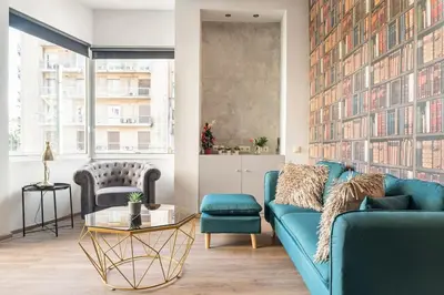 a living room with a blue couch and a table at Apt w/ View of OlympusZeusTemple/4BEDR-3BATH-2KITC in Athens