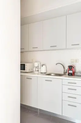 a white kitchen with white cabinets and a sink at Apt w/ View of OlympusZeusTemple/4BEDR-3BATH-2KITC in Athens