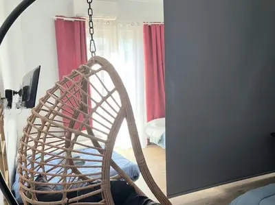 a wicker chair in a room with a mirror at Apt w/ View of OlympusZeusTemple/4BEDR-3BATH-2KITC in Athens