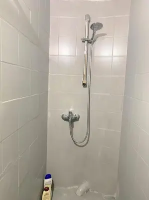 a shower in a white tiled bathroom at Apt w/ View of OlympusZeusTemple/4BEDR-3BATH-2KITC in Athens