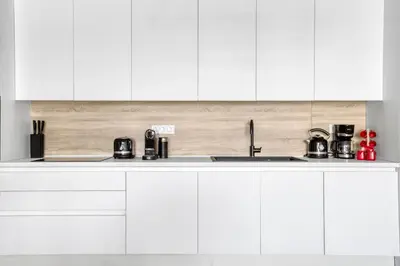 a kitchen with white cabinets and a sink at Kallirrois 89 Suite in Athens