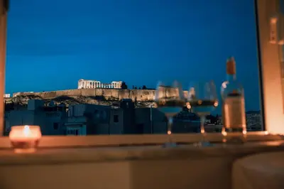 a window with two glasses and a bottle of wine at Acropoli's balcony in Athens